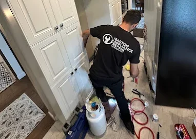 Barton Appliance Technician Fixing Appliance In Burnaby