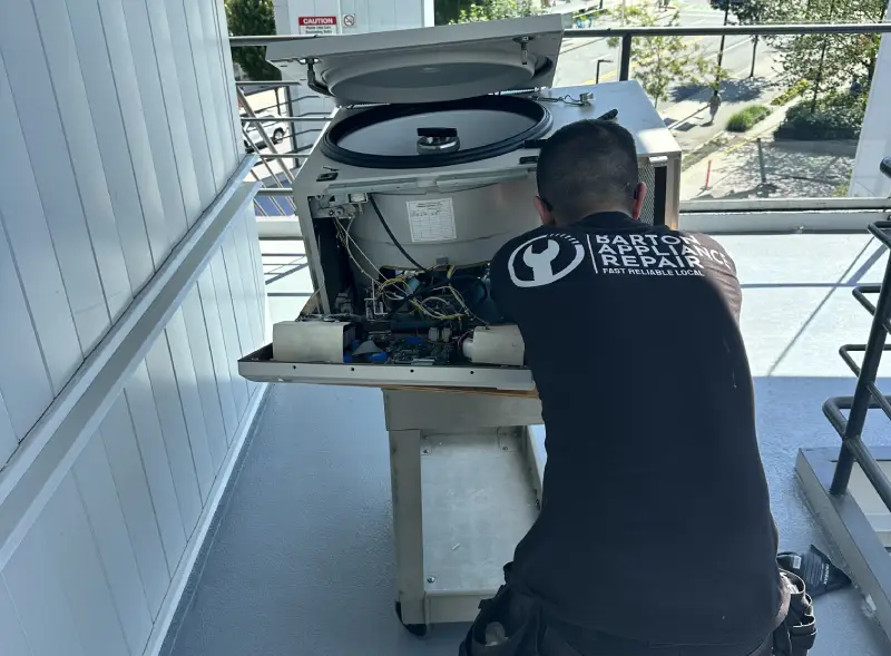 Barton Appliance Technician Fixing Appliance In Richmond
