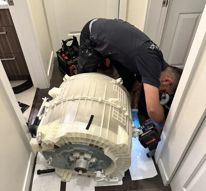 Barton Appliance Technician Fixing Appliance In Surrey